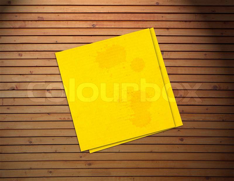 Yellow sticker paper note on vintage wood background , stock photo