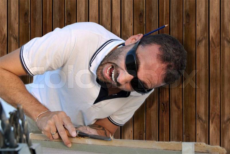 Carpenter crazy in shock with their work, stock photo