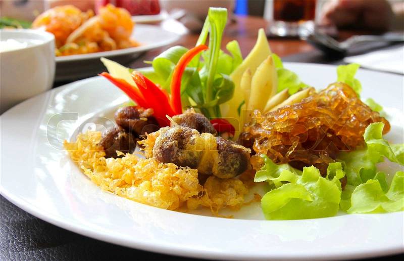 Thai food, rice in cold water served with fried sweet pork,fried egg and vegetable khao chae, stock photo
