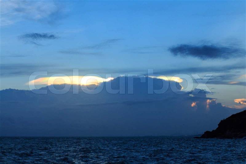 Iridescent pileus cloud or rainbow cloud over ocean, stock photo