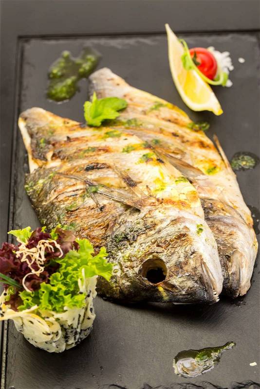 Sea fish cooked on the grill, stock photo