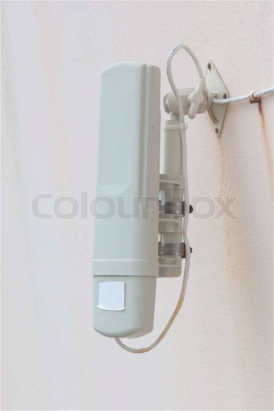 Small wifi transmitter hanging on a wall, stock photo