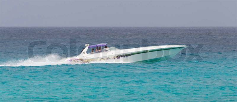 ST MARTIN - ANTILLES, JULY 19, 2013 - Speedboat with tourist on the Caribbean sea on July 19, 2013. Nearly 500.000 tourists visit St Martin every year, much for a isle with 75.000 inhabitants. ST MARTIN, July 19, 2013, stock photo