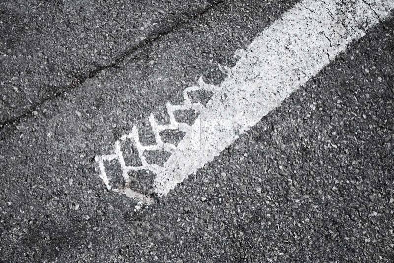 Tire track on white road marking, stock photo