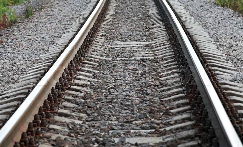 Railway perspective with gray gravel on sides, stock photo