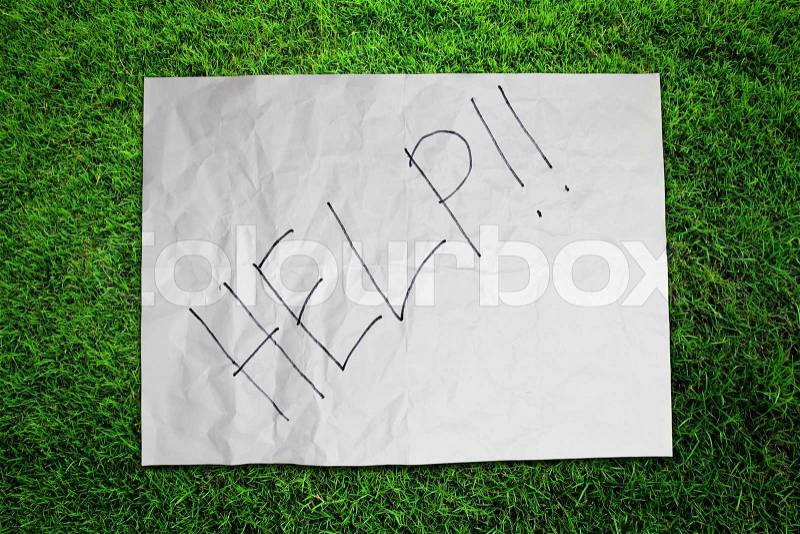 Paper Help on green grass field, stock photo