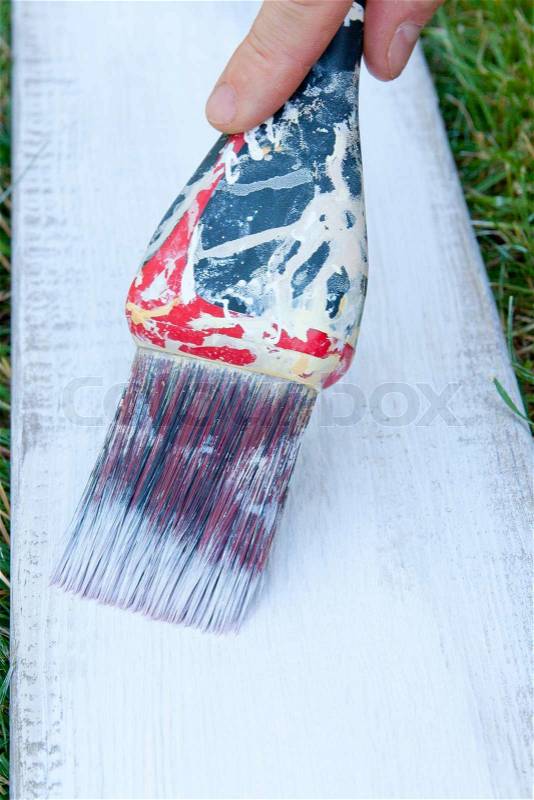 Painting board Hand with a paint brush, stock photo