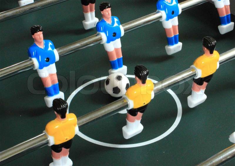 Football table game with blue and yellow players, stock photo