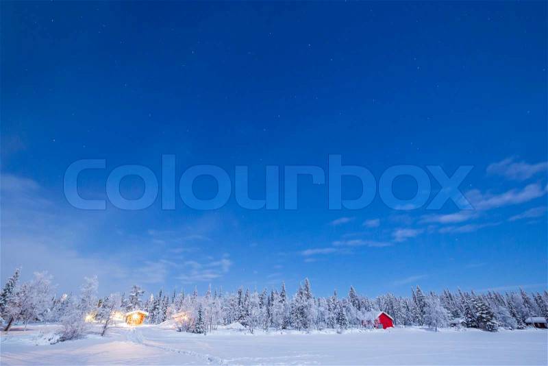 Star Trail Winter landscape with cabin hut at night in Kiruna Sweden at Night, stock photo