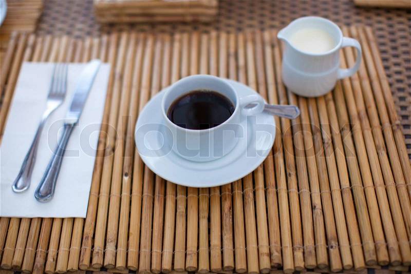 Black coffee and milk for breakfast at a cafe in the resort, stock photo