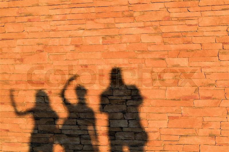 The shadow of a family on a house wall, stock photo