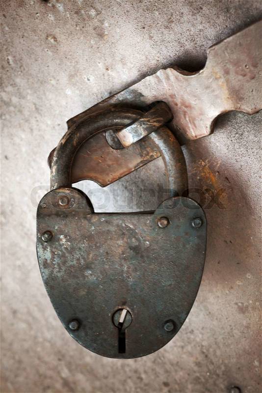 Old rusted lock hangs on metal door Close-up photo, stock photo