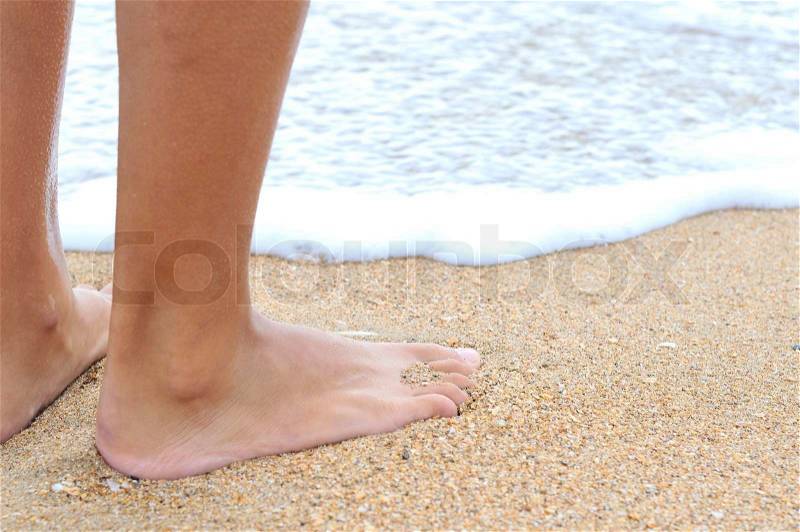 Nice legs of a pretty girl walking in water, stock photo