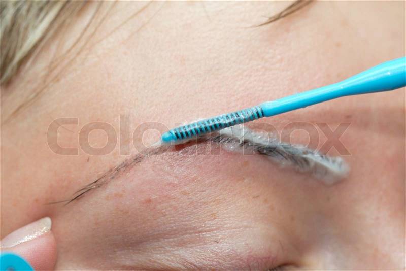 Painting eyebrows in cosmetology, stock photo
