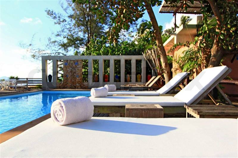 White Towel on Beach chair and Swinm pool, stock photo