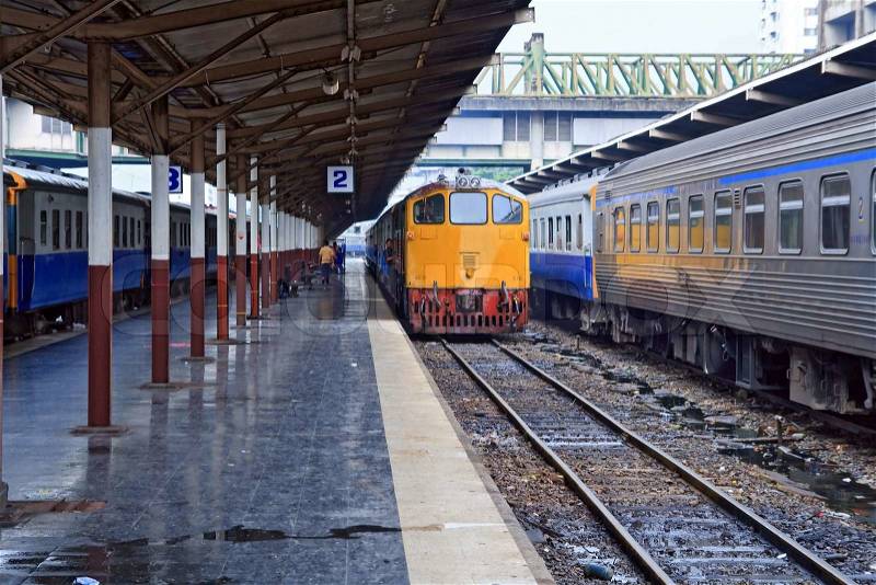 Retro orange train, diesel locomotive, on Bangkok railway station platform Thailand, stock photo