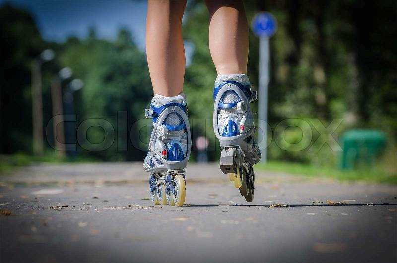 Close-up view of female legs in roller blades, stock photo