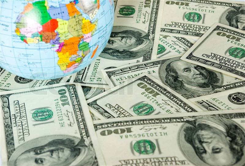 A globe and dollars is isolated on a whiteness, stock photo