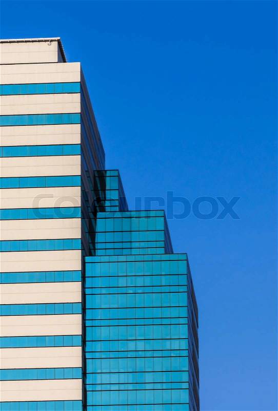 Facade of Office Building in Morning Sunlight, Blue Sky Background, stock photo