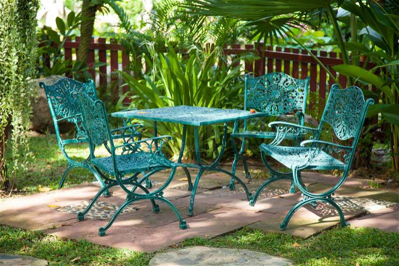 Chairs and tables, located in the garden made ​​from metal to sit in the garden, stock photo