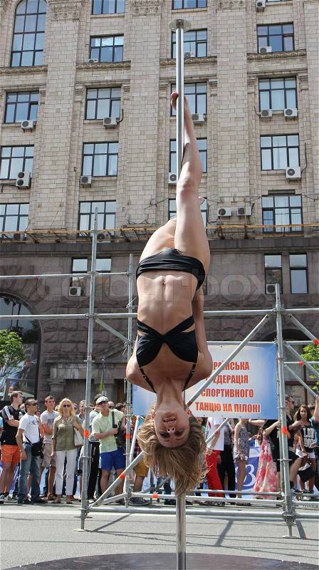KIEV, UKRAINE - JUNE 30: Unidentified pole dancer woman and spectators during Youth Day in Kiev, Ukraine on June 30, 2013, stock photo