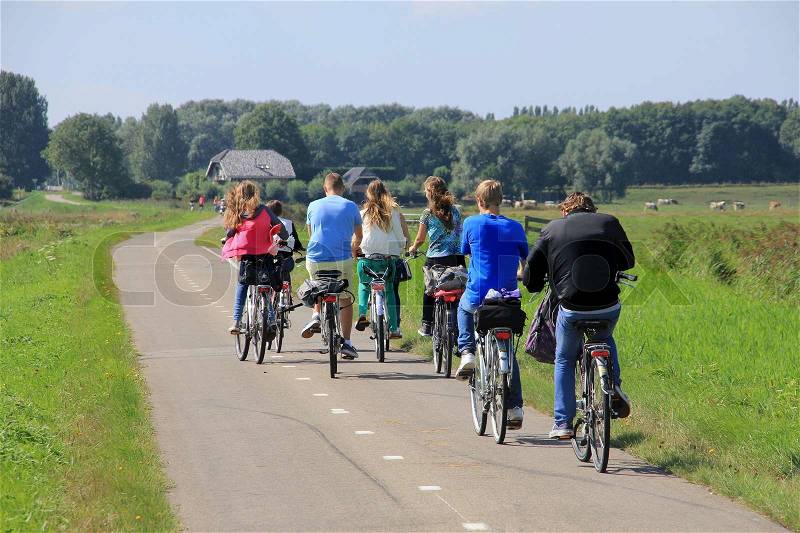 School\'s out, boyfriends and girlfriends are biking on the cycle path and going home in spring, nice ride, stock photo