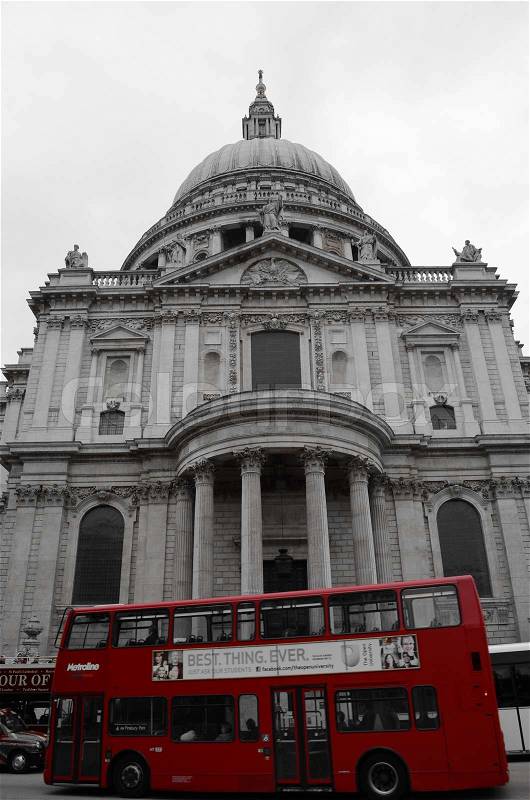 A red double London bus passing Saint Paul\'s Cathedral in downtown London, stock photo