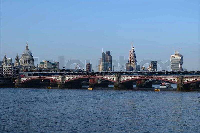 London skyline behind Blackfriars Bridge crossing the Thames, stock photo