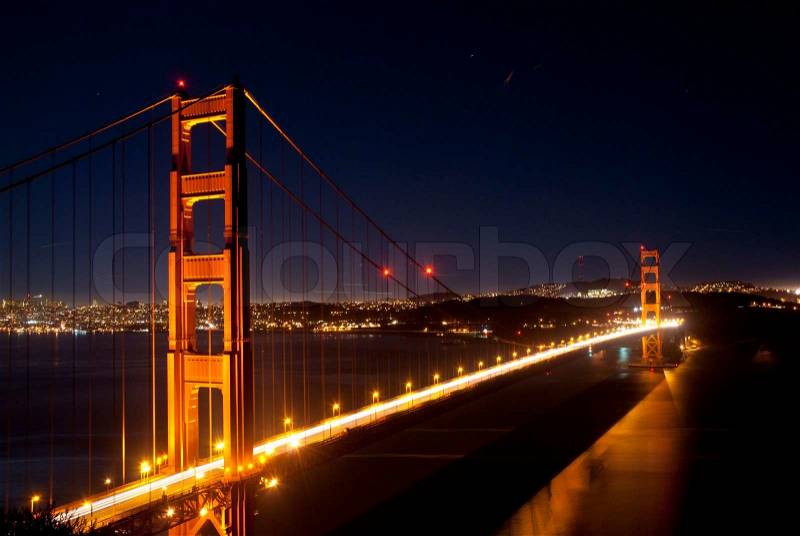 Golden Gate bridge lit up with traffic, stock photo