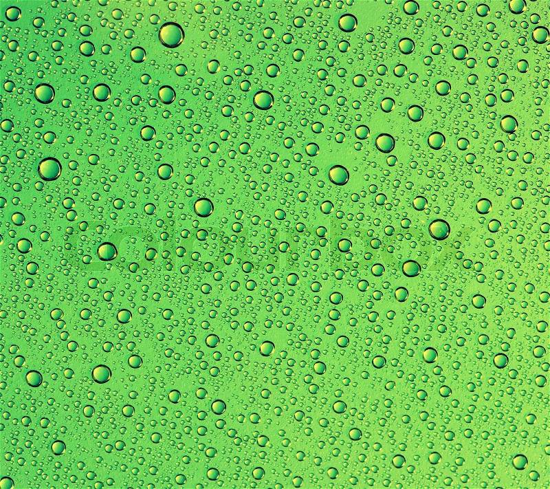 Green water drops on glass , stock photo