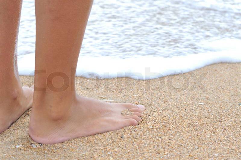 Nice legs of a pretty girl walking in water, stock photo