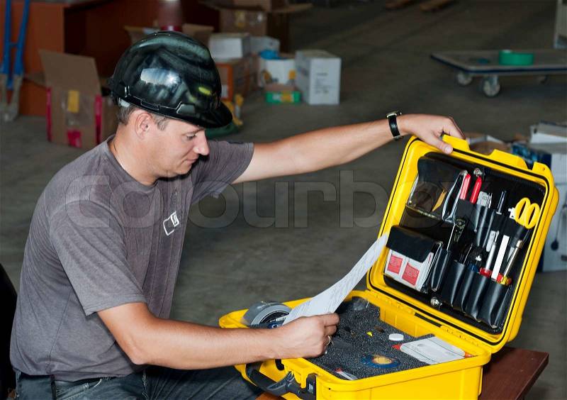 Industrial area.The engineer checks a box with tools, stock photo