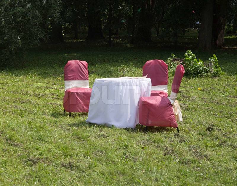 Holiday table with chairs on the nature, stock photo