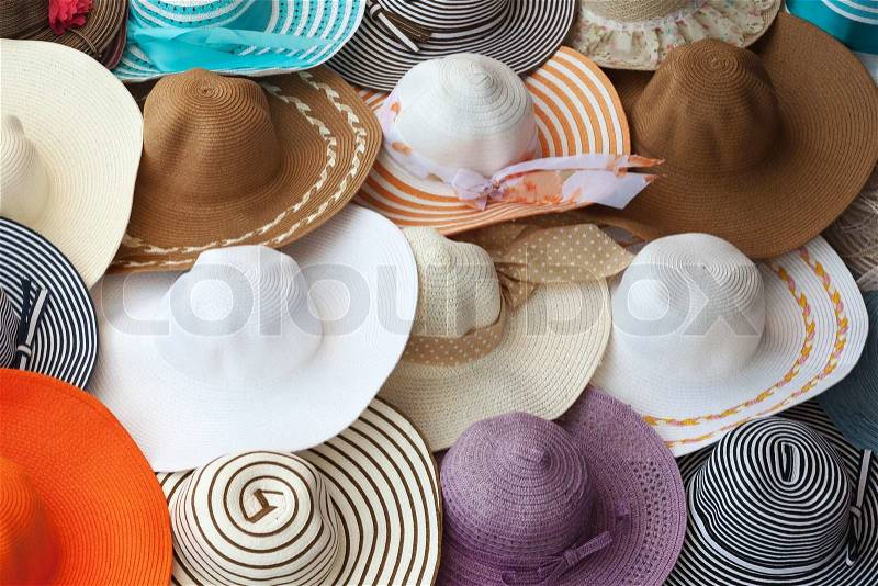 Colorful female summer hats lie on the counter, stock photo