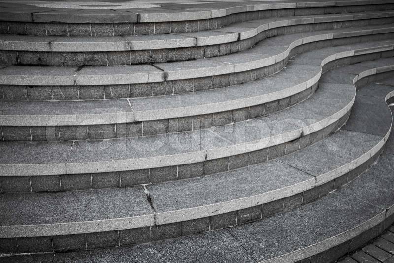 Seven curved modern gray stone stairs in the city, stock photo
