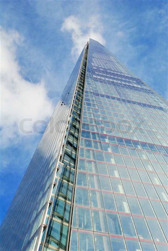 Tall office skyscraper building with clouds, stock photo