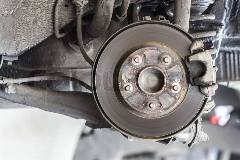 Dirty Brake Disc waiting for Maintenance in Service Garage, stock photo