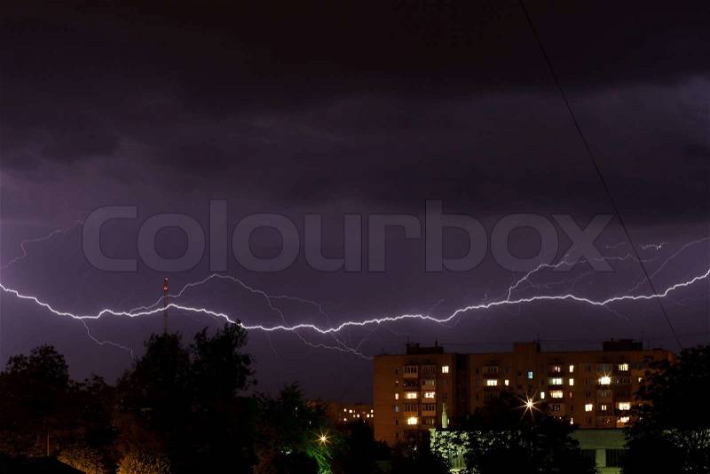Thunderstorm with lightning in the night sky over the city, stock photo