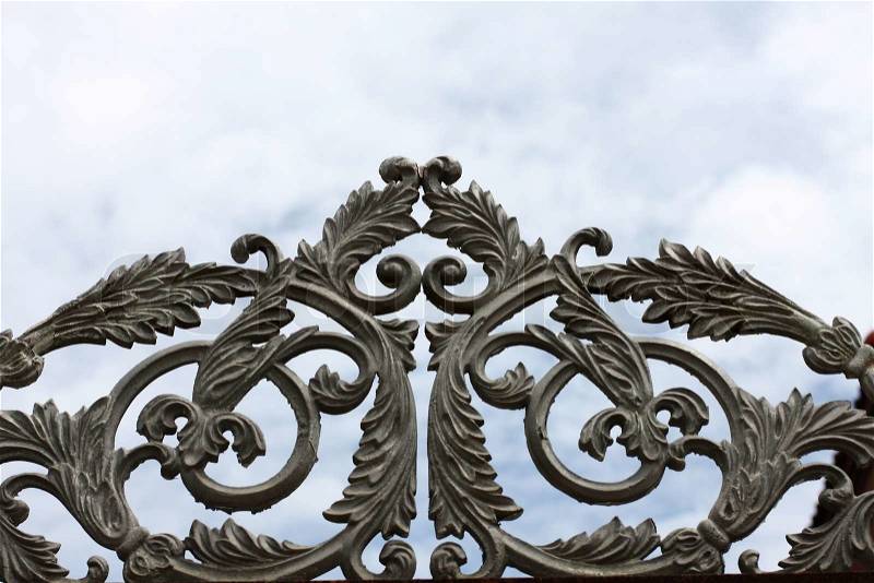 Wrought iron gate on blue sky, stock photo