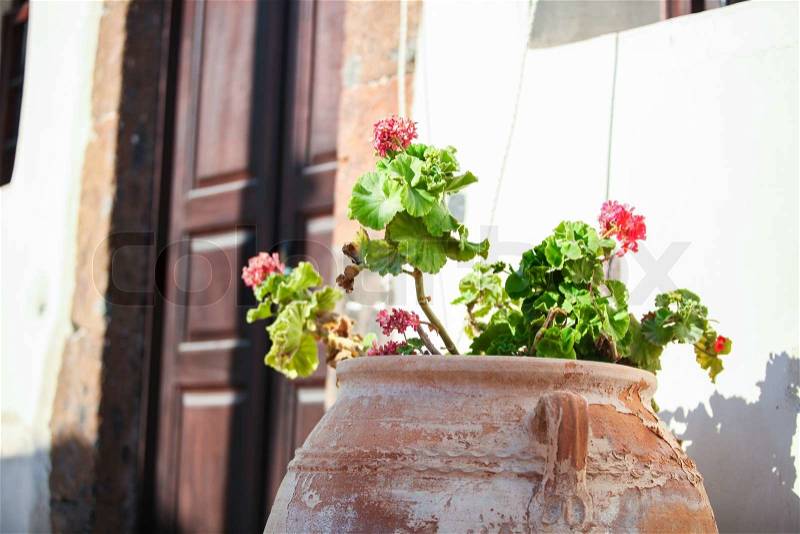 Ceramic vase in the yard near entrance at greek village Emporio, Santorini, stock photo