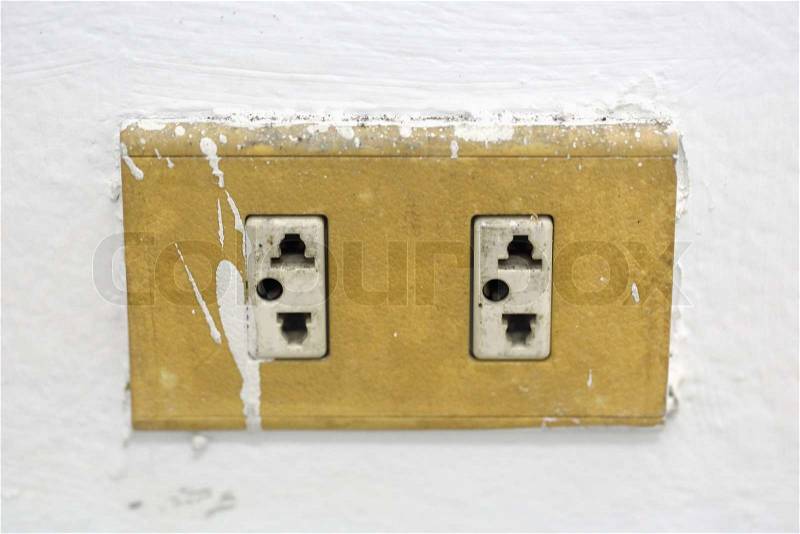 Old electrical outlet on the wall, stock photo