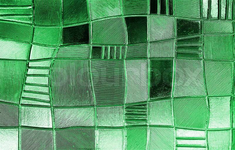 Stained glass window with irregular block pattern in a hue of green, square format, stock photo