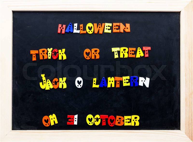 Color halloween words on clip board. words on black board, stock photo