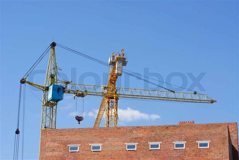 Tower cranes on blue sky background, stock photo