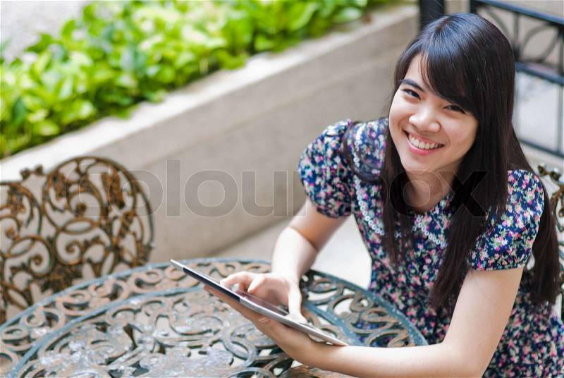 Young Asian woman using a pad PC, stock photo
