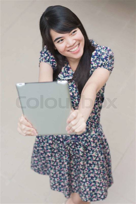 Young Asian woman using a pad PC, stock photo