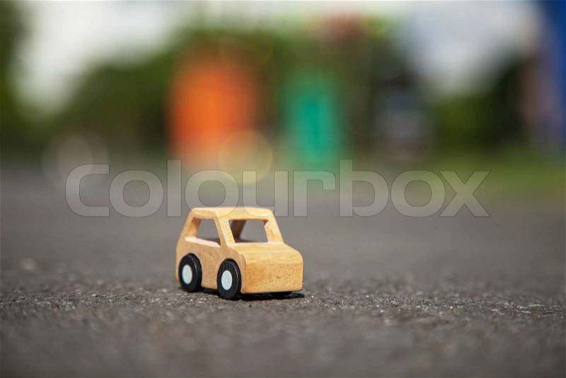 Wooden car model on the road, stock photo
