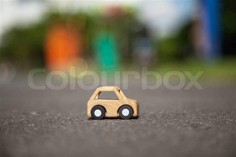 Wooden car model on the road, stock photo
