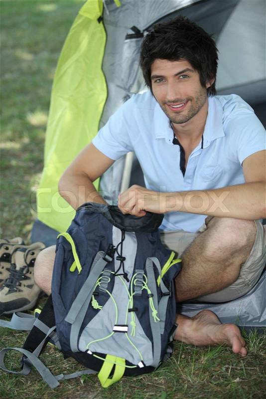 Young man camping, stock photo
