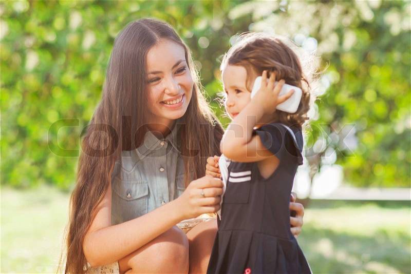 Mother and daughter walking in the park , stock photo